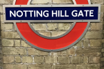 Notting Hill Gate London Underground station sign and logo on wall
