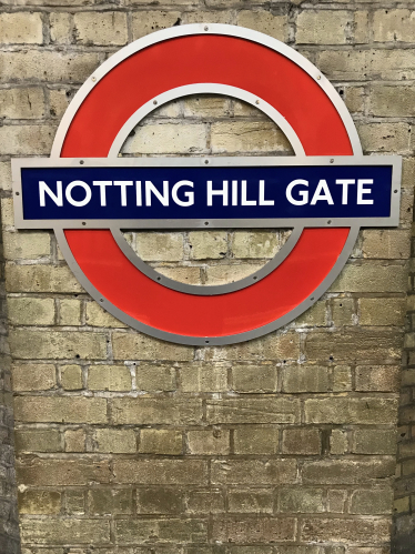 Notting Hill Gate London Underground station sign and logo on wall